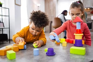 News Two young children playing with toys on a table — representing the state of U.S. childhood health.
