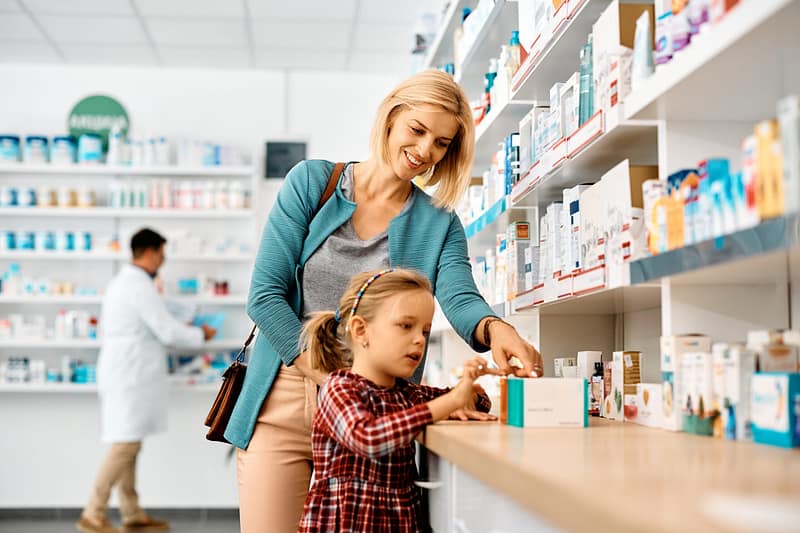 Parent Picking Out Health Supplements With Child